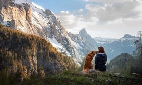 person with their dog outside